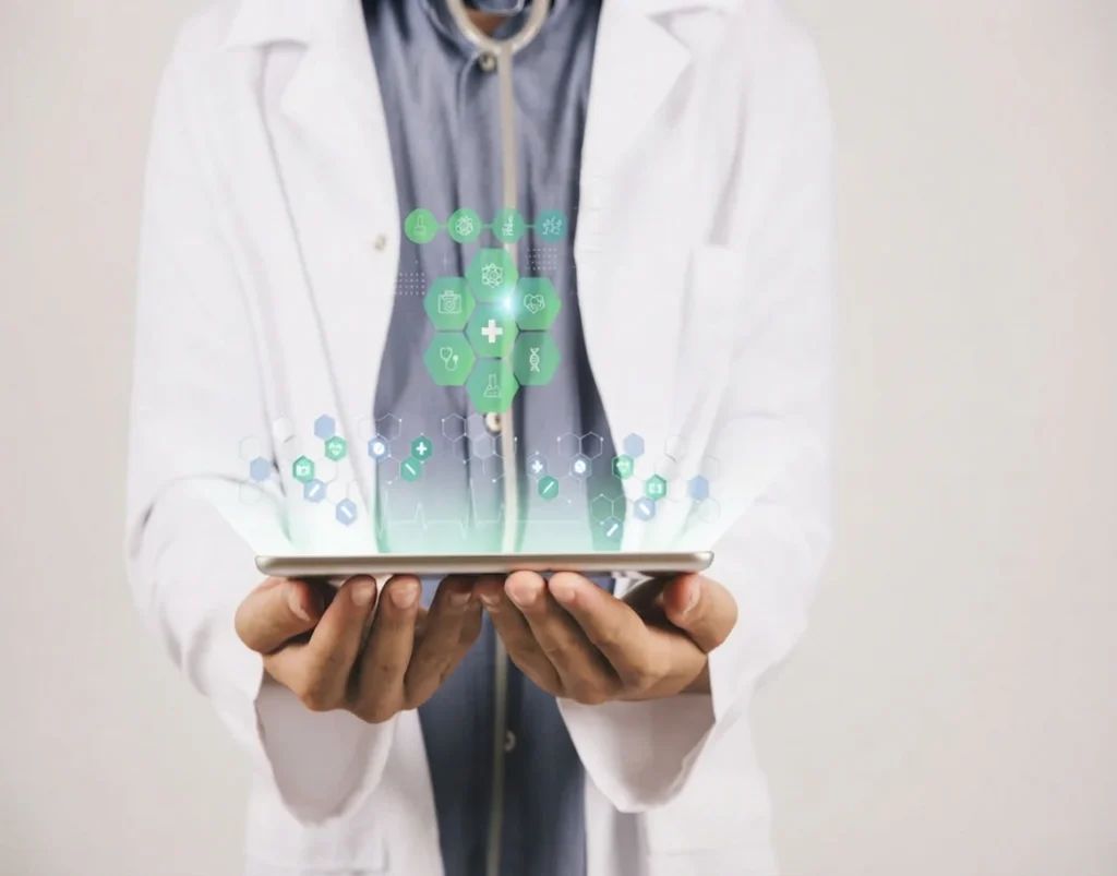 A high-definition close-up of a doctor's hands holding a tablet, projecting an intricate, glowing green medical data hologram against a clean background.